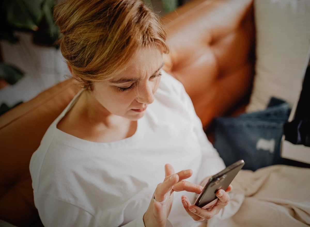 A patient at home checking her GLP-1 coaching app on her phone